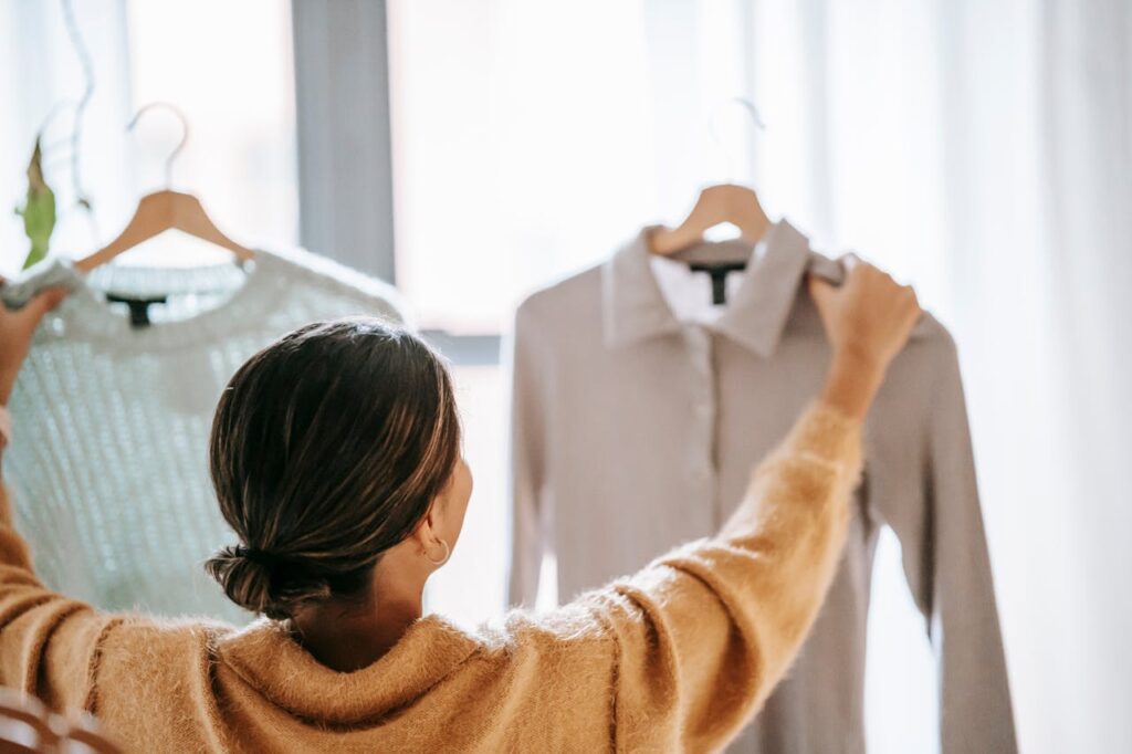 pexels-photo-6347545 Anonymous woman choosing clothes in store